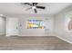 Inviting living room featuring new light hardwood floors, fresh gray paint, and abundant natural light at 113 Elm St, Henderson, NV 89015