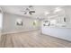 Bright, open-concept living room with light hardwood floors and a combined modern kitchen at 113 Elm St, Henderson, NV 89015