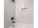 Close-up of modern shower with marble-look tile, black fixtures, and a convenient in-wall niche at 113 Elm St, Henderson, NV 89015