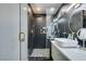 Modern bathroom featuring sleek black honeycomb tile, glass shower, and vessel sink with gold fixtures at 1352 Angel Falls St, Las Vegas, NV 89142
