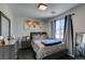 Comfortable bedroom with a world map decoration and large windows letting in natural light at 1352 Angel Falls St, Las Vegas, NV 89142