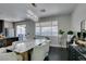 Bright dining area with large window, marble table, and stylish buffet near a sliding glass door at 1352 Angel Falls St, Las Vegas, NV 89142