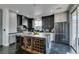 Modern kitchen featuring sleek black cabinets, stainless steel appliances, and a large island with wine storage at 1352 Angel Falls St, Las Vegas, NV 89142