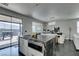 Bright open concept kitchen with island and modern cabinetry with view into outdoor living area at 1352 Angel Falls St, Las Vegas, NV 89142