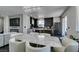 Open-concept kitchen featuring a marble dining table, a modern fireplace, and stylish black and white cabinetry at 1352 Angel Falls St, Las Vegas, NV 89142