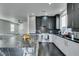 Spacious kitchen with granite island, stainless appliances, custom cabinets and view into adjacent living area at 1352 Angel Falls St, Las Vegas, NV 89142