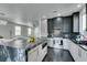 Modern kitchen with granite island, stainless appliances, custom cabinets and view into adjacent living area at 1352 Angel Falls St, Las Vegas, NV 89142