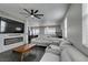 Spacious living room with fireplace, gray sectional and open floor plan to kitchen provides ample living and entertaining space at 1352 Angel Falls St, Las Vegas, NV 89142