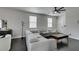 Comfortable living room with a large sectional, dark floors, and bright windows offers a welcoming and stylish space at 1352 Angel Falls St, Las Vegas, NV 89142