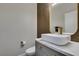 Modern powder room with a sleek vessel sink, gold fixtures and decorative tile accent wall at 1352 Angel Falls St, Las Vegas, NV 89142