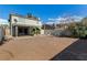 Exterior view of backyard with dirt landscaping and patio at 1704 Kismet Cir, Las Vegas, NV 89108