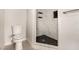 A bathroom features a shower with black tile flooring at 1704 Kismet Cir, Las Vegas, NV 89108