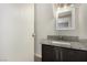 A full bathroom features a dark cabinet and granite countertops at 1704 Kismet Cir, Las Vegas, NV 89108