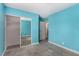 Charming bedroom offers mirrored closet, light blue walls, and doorway to adjacent spaces at 1704 Kismet Cir, Las Vegas, NV 89108