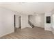 Bright living room featuring new flooring, a staircase, a closet, and fresh paint for a modern feel at 1704 Kismet Cir, Las Vegas, NV 89108