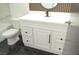 Bathroom vanity with white cabinets, a black faucet, and black marble flooring at 1805 Amboy Dr, Las Vegas, NV 89108