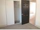 A bedroom with gray carpet, a sliding door closet, and a black interior door at 1805 Amboy Dr, Las Vegas, NV 89108