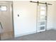 This bedroom features a stylish sliding barn door and neutral color palette at 1805 Amboy Dr, Las Vegas, NV 89108