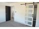 This bedroom features a stylish sliding barn door and neutral color palette at 1805 Amboy Dr, Las Vegas, NV 89108