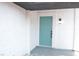 Charming front entrance featuring a stylish teal door and modern sconce lighting at 1805 Amboy Dr, Las Vegas, NV 89108
