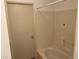 Simple bathroom featuring a shower-tub combination with white tile surround at 1830 N Pecos Rd # 252, Las Vegas, NV 89115