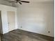 Bedroom with wood-look flooring, a ceiling fan, and white door at 1830 N Pecos Rd # 252, Las Vegas, NV 89115