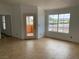 Bright living room featuring tile floors, a large window, and a glass door leading to a balcony at 1830 N Pecos Rd # 252, Las Vegas, NV 89115