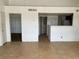 Open concept living room with tile flooring adjacent to the kitchen and access to the bedroom at 1830 N Pecos Rd # 252, Las Vegas, NV 89115