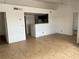Open living room featuring tile floors, bright white walls, and a pass-through to the kitchen at 1830 N Pecos Rd # 252, Las Vegas, NV 89115
