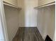 Walk-in closet with built-in shelving and wood-look flooring at 1830 N Pecos Rd # 252, Las Vegas, NV 89115