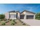 Modern, single-story home with a desert landscape, brick accents and a three car garage at 213 Dolce Viale Ct, Henderson, NV 89011
