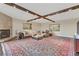 Open living area with fireplace, wooden ceiling beams and expansive rug perfect for entertaining at 2777 Paradise Rd # 2001, Las Vegas, NV 89109
