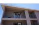 Second-story balcony with railing and glass paneled door; building has stucco exterior and overhang at 2898 Violet Ln # 0, Henderson, NV 89074
