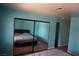 Bedroom with mirror sliding closet doors and blue walls at 2898 Violet Ln # 0, Henderson, NV 89074