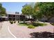 Beautifully landscaped condo complex with lush green lawns, trees, and colorful flowering bushes at 2898 Violet Ln # 0, Henderson, NV 89074