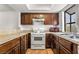Kitchen features wood cabinets, granite counters and stainless steel appliances at 2898 Violet Ln # 0, Henderson, NV 89074
