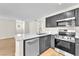 Modern kitchen with stainless steel appliances, white countertops, and gray cabinetry at 2964 Juniper Hills Blvd # 104, Las Vegas, NV 89142