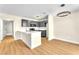 A modern kitchen with bar seating and stainless steel appliances overlooks dining area with decorative lighting at 2964 Juniper Hills Blvd # 104, Las Vegas, NV 89142