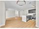 Open-concept living area with hardwood floors and a modern kitchen at 2964 Juniper Hills Blvd # 104, Las Vegas, NV 89142