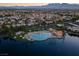 Aerial view of lake with a community pool, cabanas, and lush trees at 3150 Soft Breezes Dr # 2186, Las Vegas, NV 89128