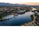 Beautiful aerial view of the community featuring a lake, pool and mountain views at 3150 Soft Breezes Dr # 2186, Las Vegas, NV 89128