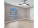 Neutral bedroom features a large arched window and ceiling fan, creating a comfortable living space at 3150 Soft Breezes Dr # 2186, Las Vegas, NV 89128