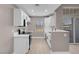 Well-lit kitchen featuring white cabinets, stainless steel appliances and sink, and a stylish arched window at 3150 Soft Breezes Dr # 2186, Las Vegas, NV 89128