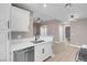 Modern kitchen featuring white cabinets, stainless steel appliances, and open access to adjacent living space at 3150 Soft Breezes Dr # 2186, Las Vegas, NV 89128