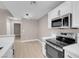 Modern eat-in kitchen featuring white cabinets, stainless steel appliances, and a pendant lighting fixture at 3150 Soft Breezes Dr # 2186, Las Vegas, NV 89128