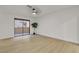 Spacious bedroom with hardwood floors, neutral walls, ceiling fan, and a sliding glass door to a balcony at 3151 Soaring Gulls Dr # 1179, Las Vegas, NV 89128