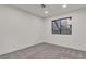 This bedroom has a large window and neutral carpet, and it is naturally well-lit at 3151 Soaring Gulls Dr # 1179, Las Vegas, NV 89128