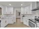 Bright kitchen featuring white cabinets, marble countertops, stainless steel appliances, and hardwood floors at 3151 Soaring Gulls Dr # 1179, Las Vegas, NV 89128