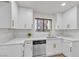 Modern kitchen featuring white cabinets, marble countertops, stainless steel appliances, and hardwood floors at 3151 Soaring Gulls Dr # 1179, Las Vegas, NV 89128