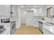 Bright kitchen featuring white cabinets, marble countertops, stainless steel appliances, and hardwood floors at 3151 Soaring Gulls Dr # 1179, Las Vegas, NV 89128